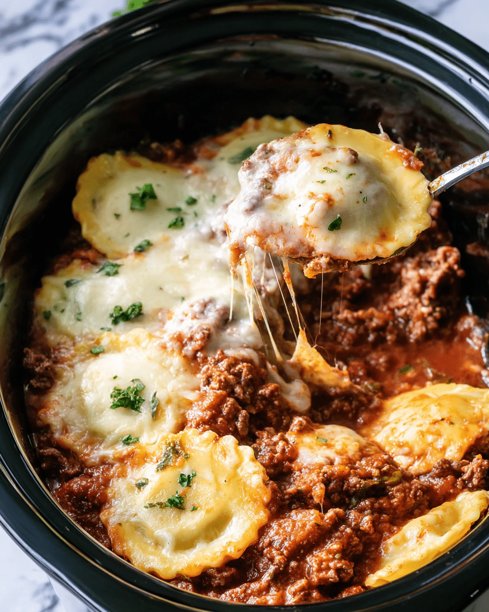 The image shows a slow cooker filled with a layered ravioli dish. The bottom layer is a rich, chunky red meat sauce with visible ground beef. Above that, there is a layer of round ravioli with a slightly golden edge, covered with melted, creamy white cheese that stretches as a spoon lifts one ravioli out. Small green parsley pieces are scattered on top for garnish. The slow cooker is black, contrasting with the food inside, and the background has a white marbled texture. Photo taken with an iphone --ar 4:5 --v 7