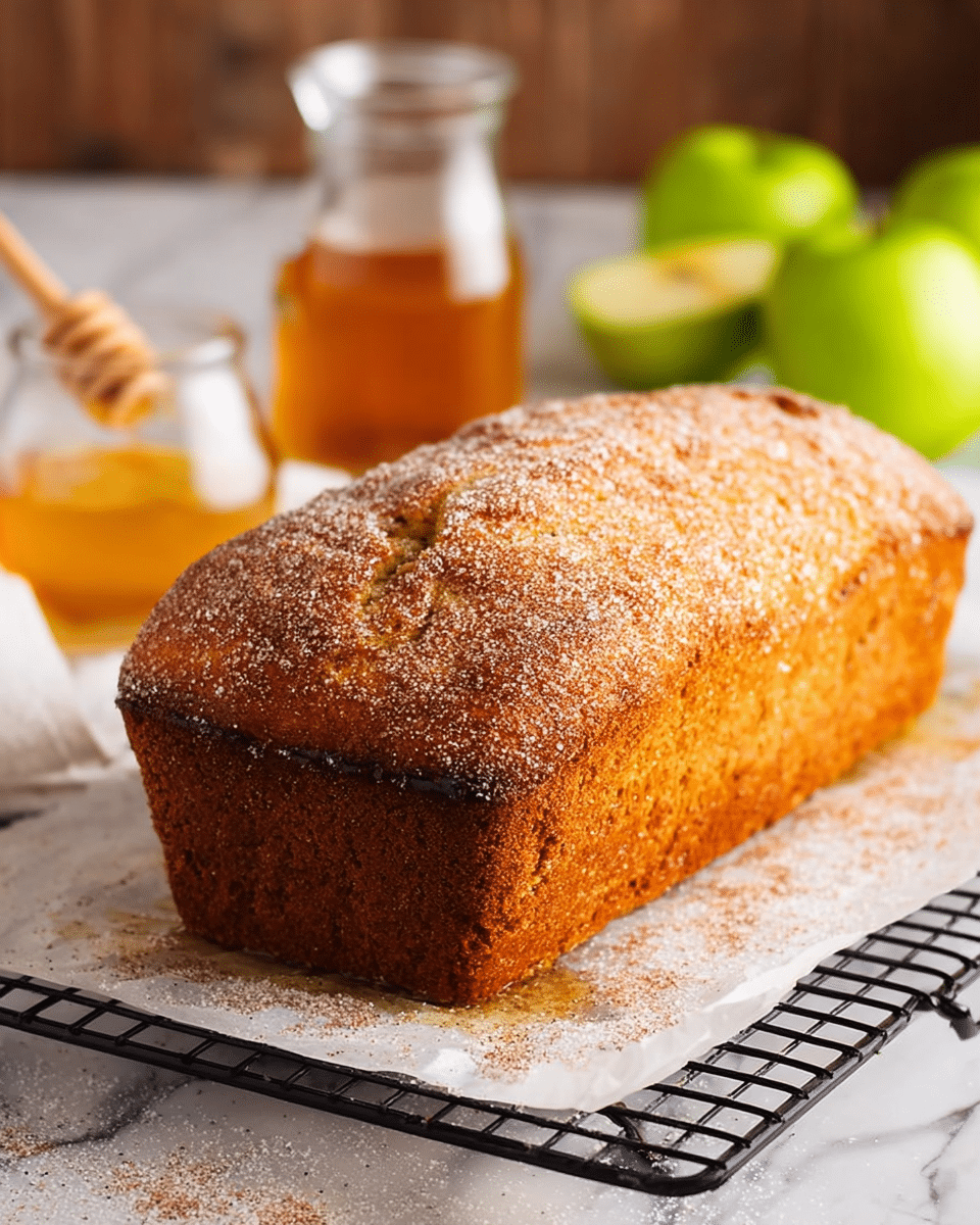 A stack of three thick slices of cinnamon sugar-coated bread with a rough, crunchy brown crust and a soft, light tan inner texture, arranged one on top of another on a white plate, next to two cinnamon sticks on the right; in the background, a bright green apple and a small white bowl with a light beige spread are visible on a white marbled surface. photo taken with an iphone --ar 4:5 --v 7