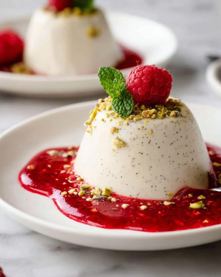 Creamy Vanilla Panna Cotta with Raspberry Coulis and Pistachio Topping Recipe