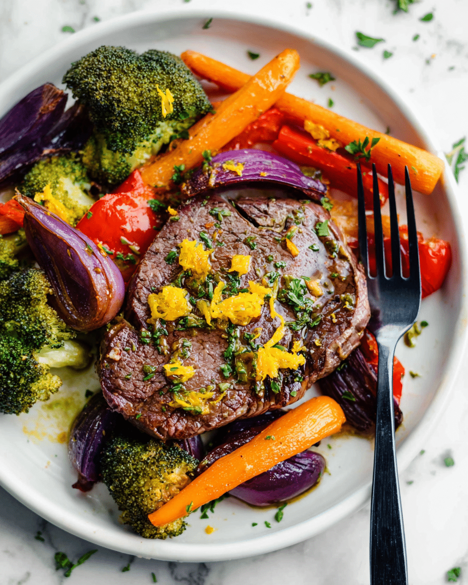 A white round plate holds a grilled steak at the center, topped with small yellow zest pieces and green herb sprinkles. Around the steak, there are roasted vegetables including bright orange carrot slices, green broccoli florets with slightly charred edges, deep purple onion chunks, and red bell pepper pieces, all showing a caramelized, cooked texture. A black fork is placed on the right side of the steak, with its prongs touching the meat. The plate rests on a white marbled surface with some scattered green herbs. Photo taken with an iphone --ar 4:5 --v 7