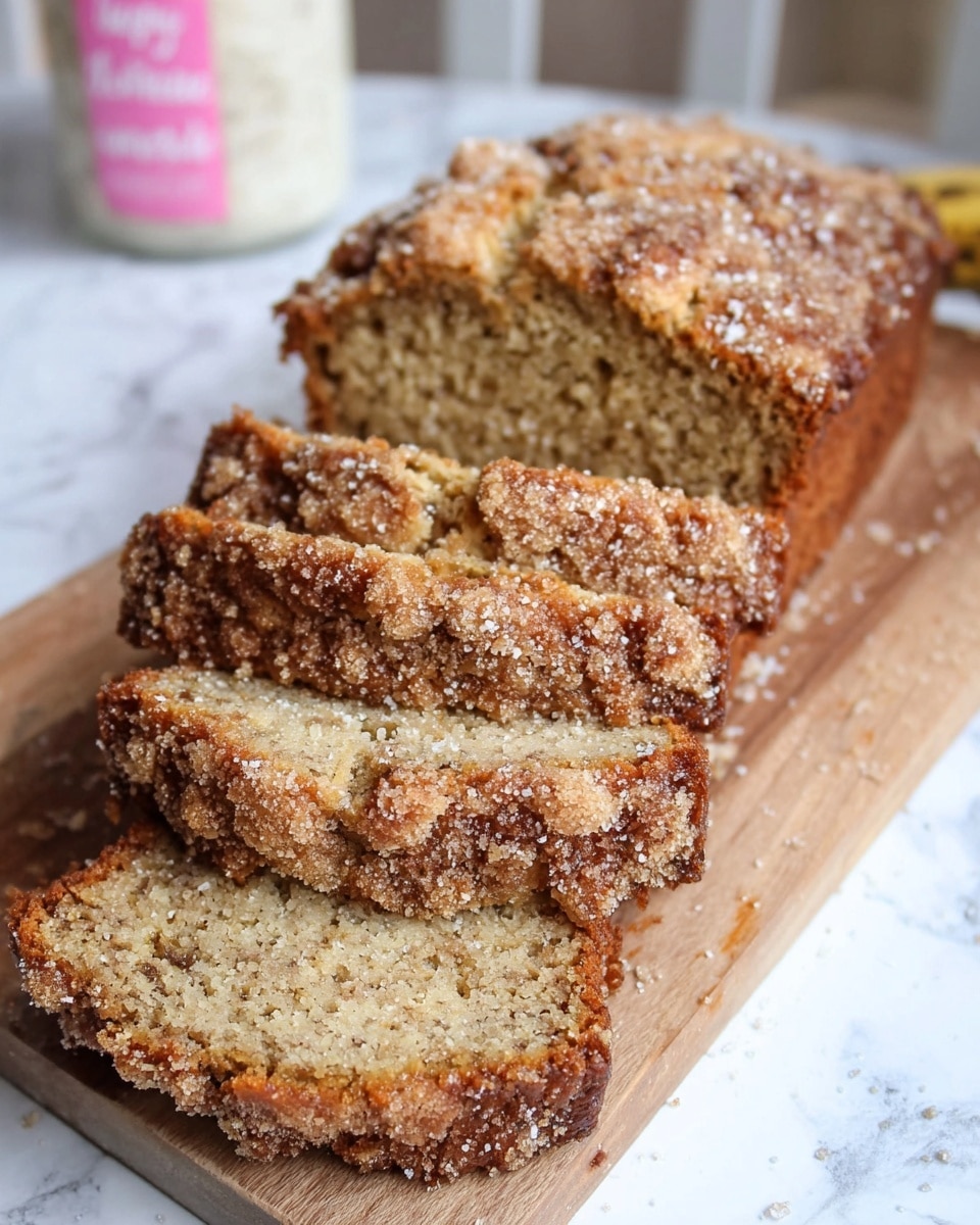 A loaf of banana bread sliced into five thick pieces sits on a wooden board over a white marbled surface. The bread has a golden-brown crust with a crumbly topping of light brown sugar and coarse white sugar sprinkled unevenly across the top. Inside, the bread is moist with a textured, speckled light tan color, showing bits of banana and a soft crumb. In the blurred background, there is a white jar with pink text. photo taken with an iphone --ar 4:5 --v 7