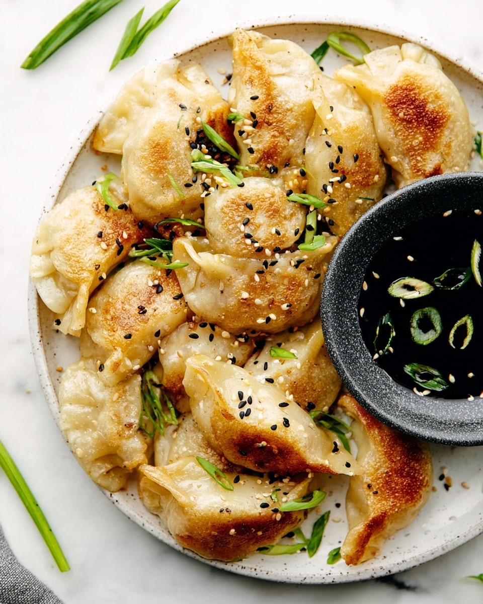 The image shows close-up golden brown dumplings with crisp edges, topped with scattered white and black sesame seeds. Each dumpling has a soft, folded wrapper with some browned spots, paired with small pieces of bright green sliced scallions scattered throughout. The dumplings rest in a white bowl with a rough-textured dark gray element partially visible on the right side, and the background is a white marbled texture. The dumplings appear slightly shiny, suggesting a light coating of oil or sauce. photo taken with an iphone --ar 4:5 --v 7