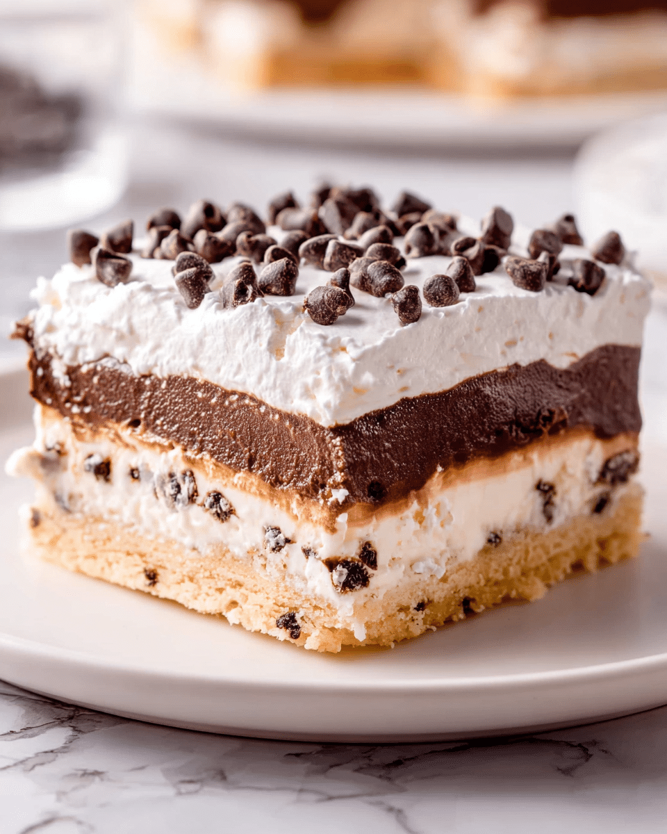 A square layered dessert sits on a white plate over a white marbled surface. The bottom layer is a thick, light golden cookie crust with visible chocolate chips. Above it is a thinner, creamy white layer, topped by a thick, smooth dark chocolate layer with a few bubbles visible. The topmost layer is fluffy white whipped cream, scattered generously with small, dark chocolate chips. The edges of each layer are clean and well-defined, showing clear separation between textures. Photo taken with an iphone --ar 4:5 --v 7