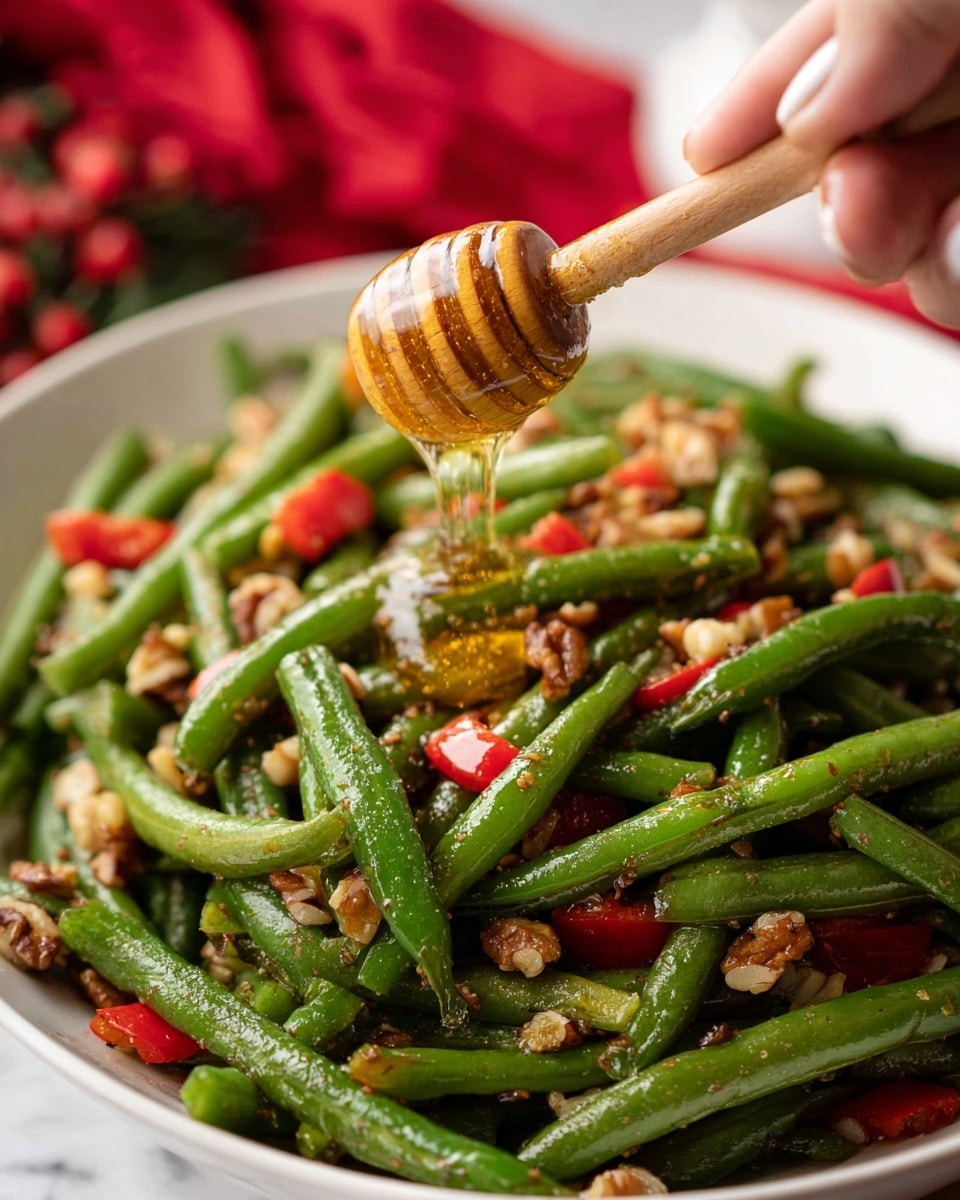 A white plate filled with glossy green beans as the main layer, cut into medium pieces with some whole and some slightly split. Scattered evenly over and mixed with the green beans are small, rough pieces of chopped nuts, light brown in color, and tiny bits of bright red diced peppers adding a splash of color. A silver spoon rests on the edge of the plate. The plate is placed on a white marbled surface with small Christmas ornaments and a piece of frosted plant nearby, creating a festive mood. Photo taken with an iphone --ar 4:5 --v 7