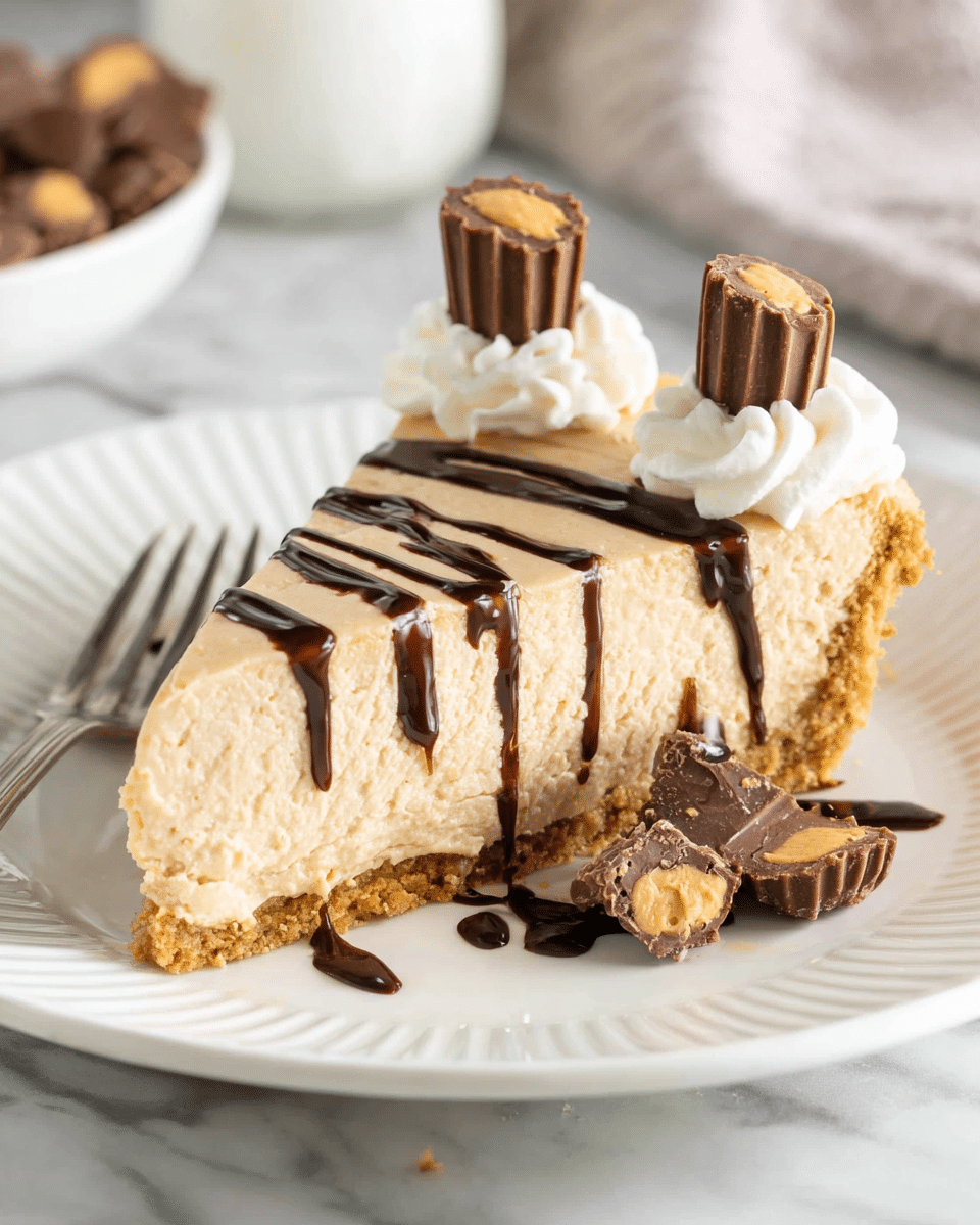 A slice of creamy light brown peanut butter cheesecake with a crumbly beige crust sits centered on a white plate with a ridged edge, placed on a white marbled surface. The cheesecake has two small dollops of white whipped cream near the wider side, each topped with a small chocolate peanut butter cup. Dark chocolate syrup is drizzled in uneven lines diagonally across the top and around the plate. Pieces of broken chocolate peanut butter cups are scattered near the front of the slice, adding texture and detail. A silver fork is placed at the bottom left corner of the plate. Photo taken with an iphone --ar 4:5 --v 7